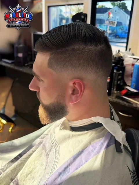 Fade with side part and shaped beard