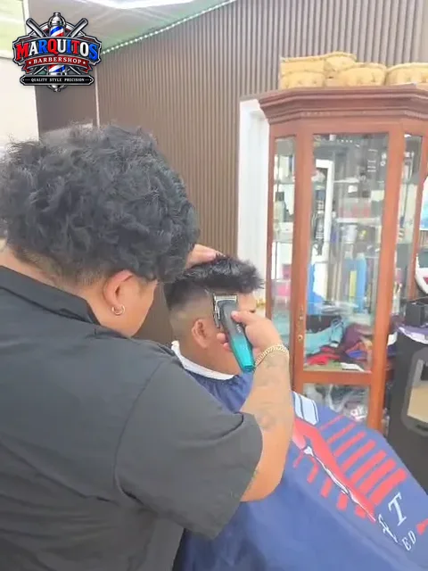 Marcos working on a fade with clippers